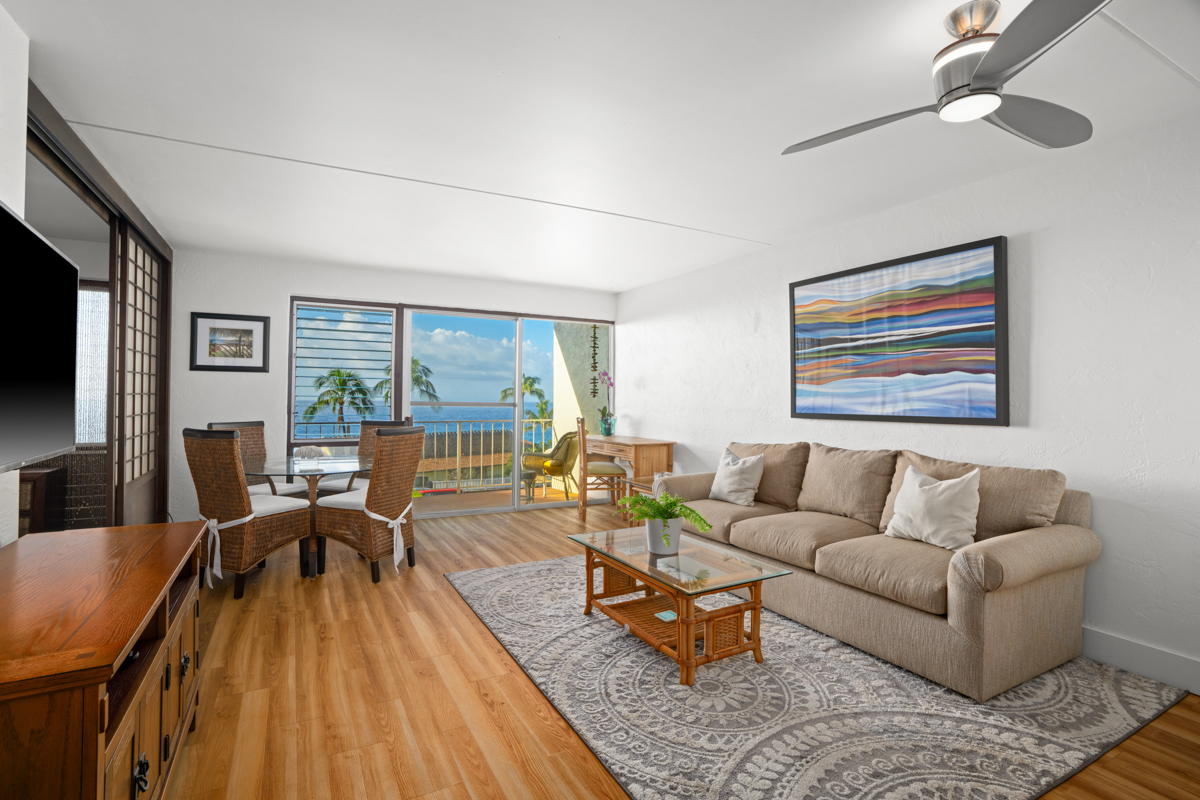 1763 Pe'e Road, Unit 206 Koloa, HI 96756 - Photo 2 of 2 a living room with furniture and a large window