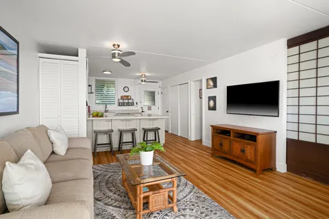 a living room with fireplace furniture and a flat screen tv