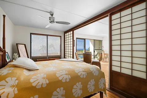 a bedroom with a bed and a large window