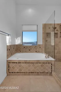 a bathroom with a granite countertop sink a light fixture and a mirror