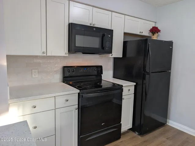 a kitchen with a refrigerator stove and microwave