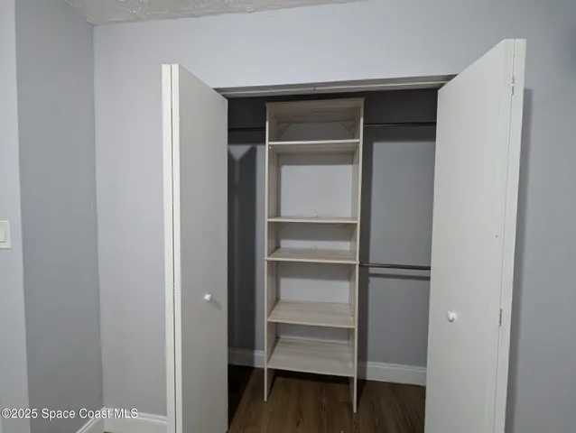 a view of walk in closet with empty racks