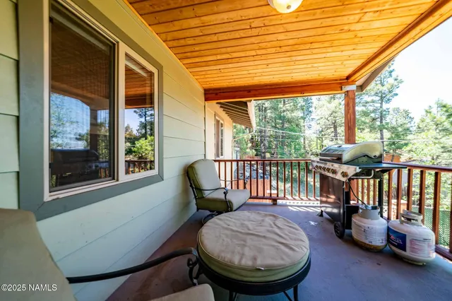 a view of a porch with furniture and a yard