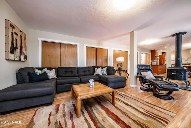 a view of living room kitchen with furniture and wooden floor