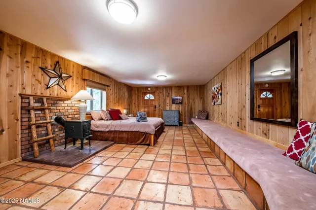 a bedroom with a large bed and a chandelier