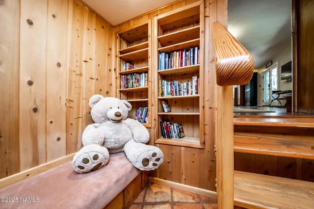 a view of a house with a yard and large tree