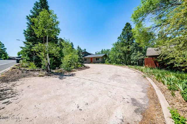 a view of a house with backyard and deck