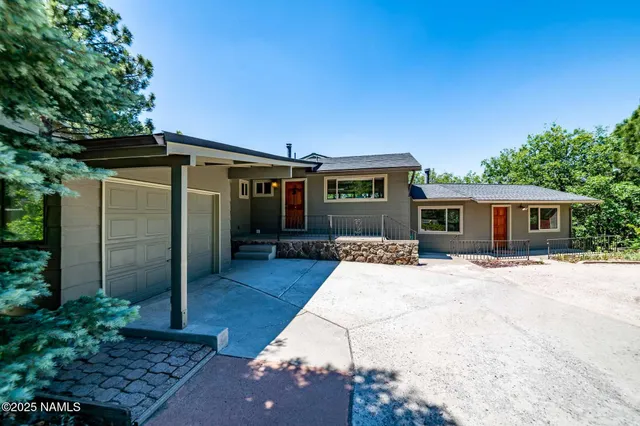a view of outdoor sitting area with furniture and wooden fence