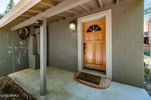 a view of a house with table and chairs in a patio