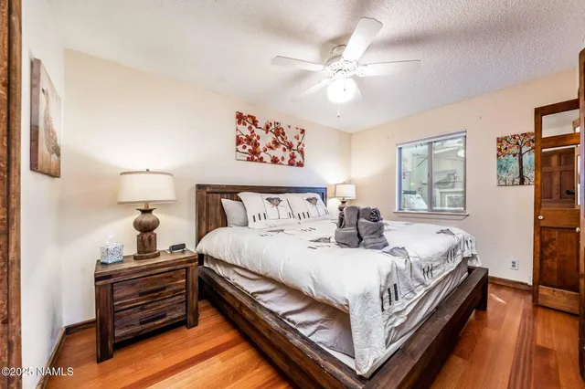 a bathroom with a granite countertop sink a toilet a mirror and shower