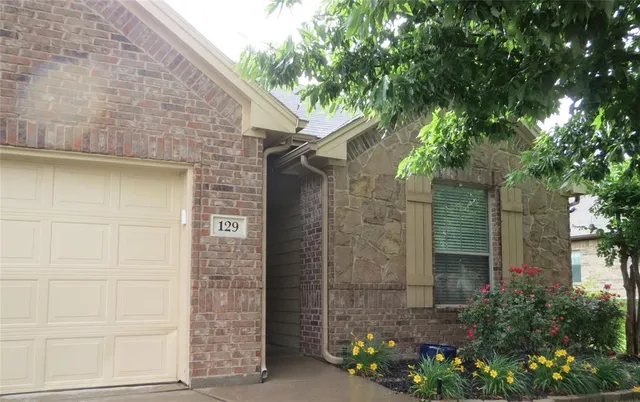 a stone house with a trees in front of it