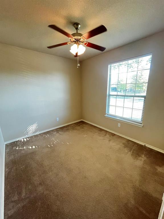 129 Sierra Drive Waxahachie, TX 75167 - Photo 11 of 24 an empty room with a window and a ceiling fan