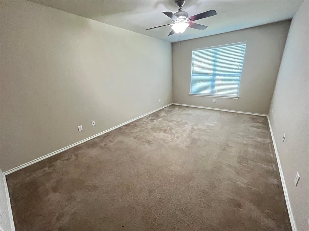 129 Sierra Drive Waxahachie, TX 75167 - Photo 15 of 24 an empty room with a window and a fan