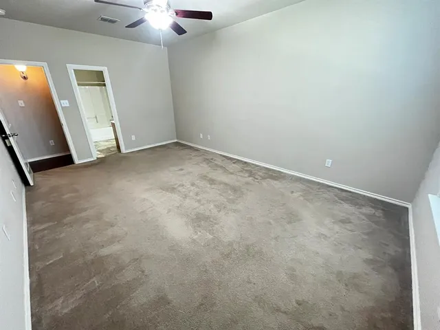 an empty room with a ceiling fan