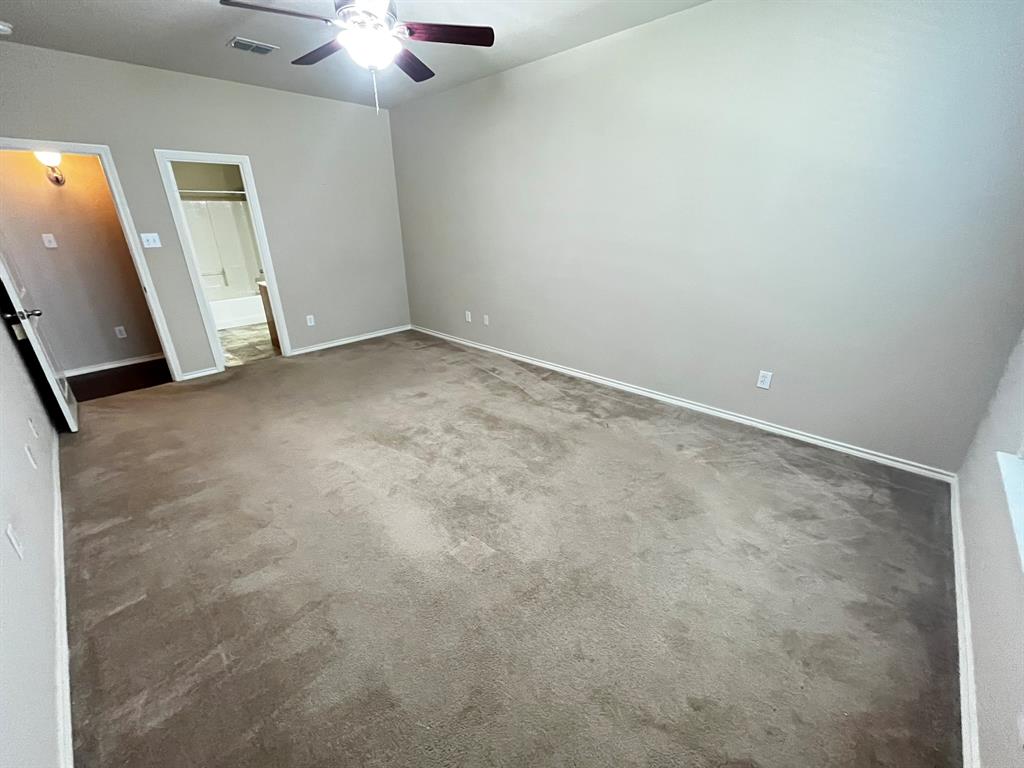 129 Sierra Drive Waxahachie, TX 75167 - Photo 16 of 24 an empty room with a ceiling fan