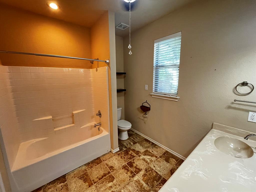 129 Sierra Drive Waxahachie, TX 75167 - Photo 20 of 24 a bathroom with a sink and a bathtub