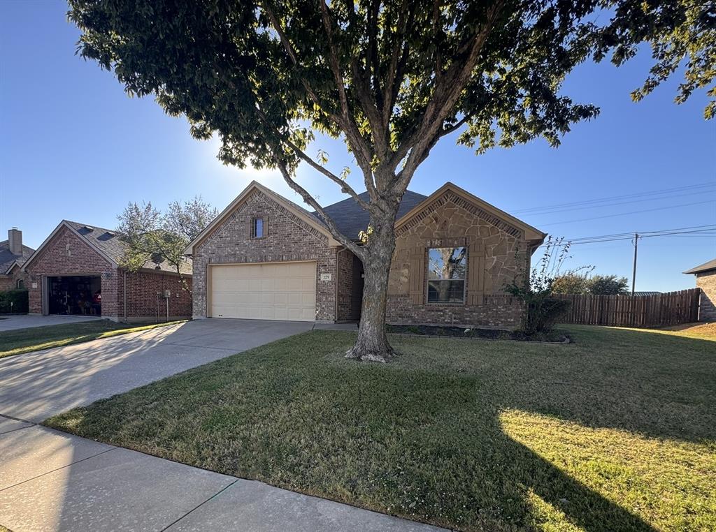 129 Sierra Drive Waxahachie, TX 75167 - Photo 2 of 24 a front view of a house with a yard and garage