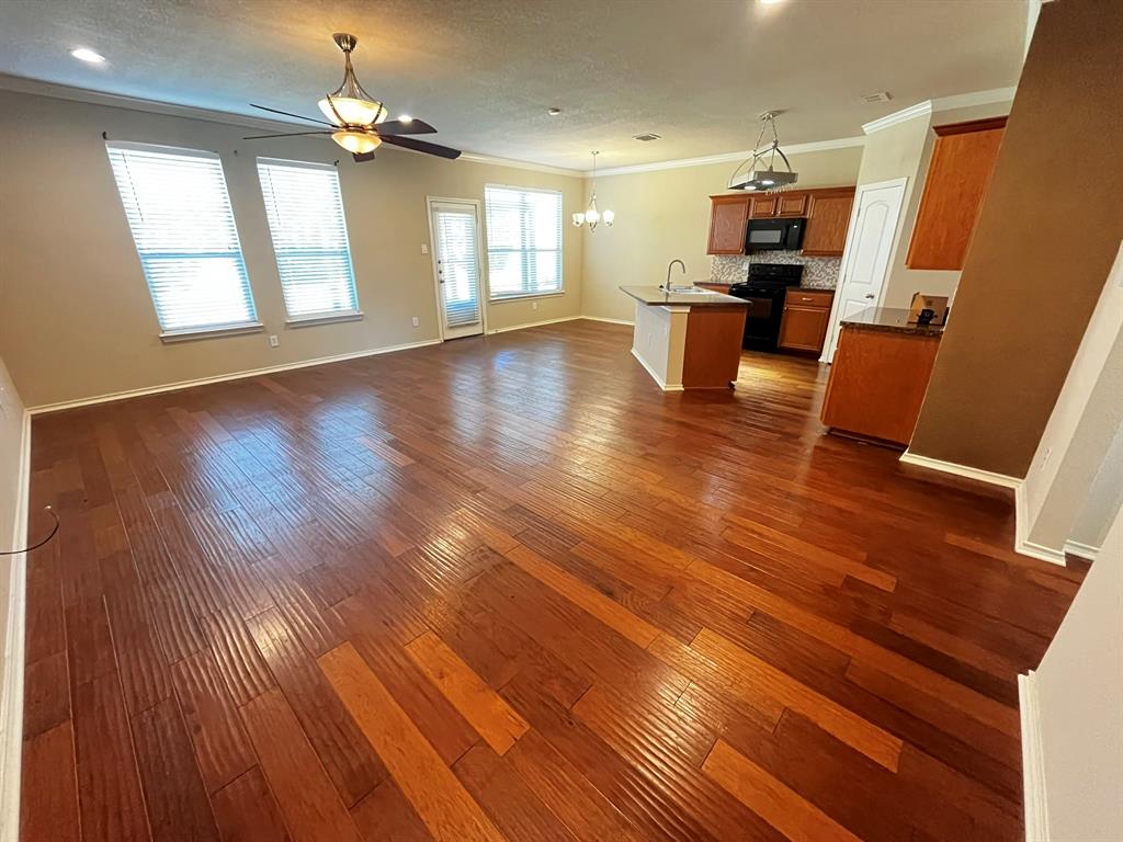 129 Sierra Drive Waxahachie, TX 75167 - Photo 3 of 24 an open kitchen with wooden floor and window