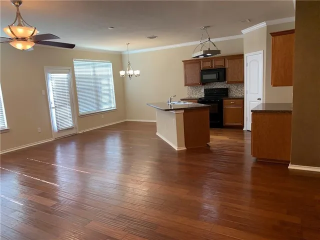 a kitchen with granite countertop a stove and a refrigerator
