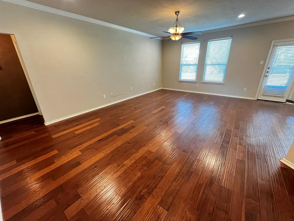 129 Sierra Drive Waxahachie, TX 75167 - Photo 8 of 24 wooden floor in an empty room with a window