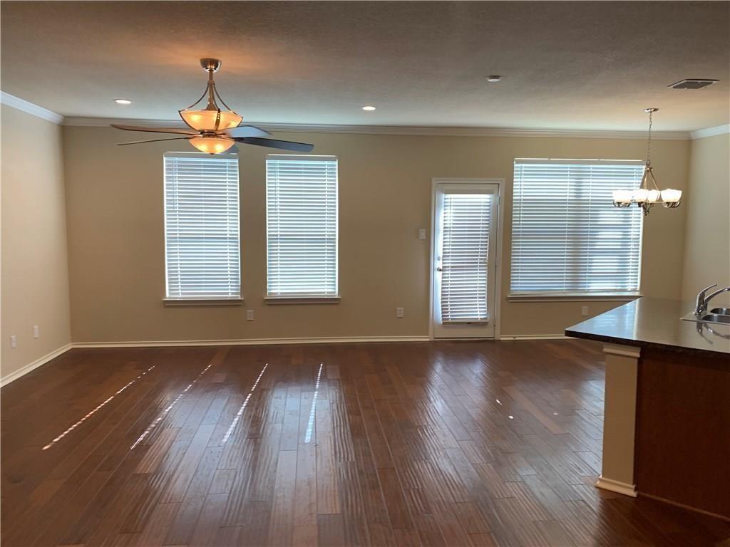 129 Sierra Drive Waxahachie, TX 75167 - Photo 9 of 24 a view of an empty room with wooden floor and a window