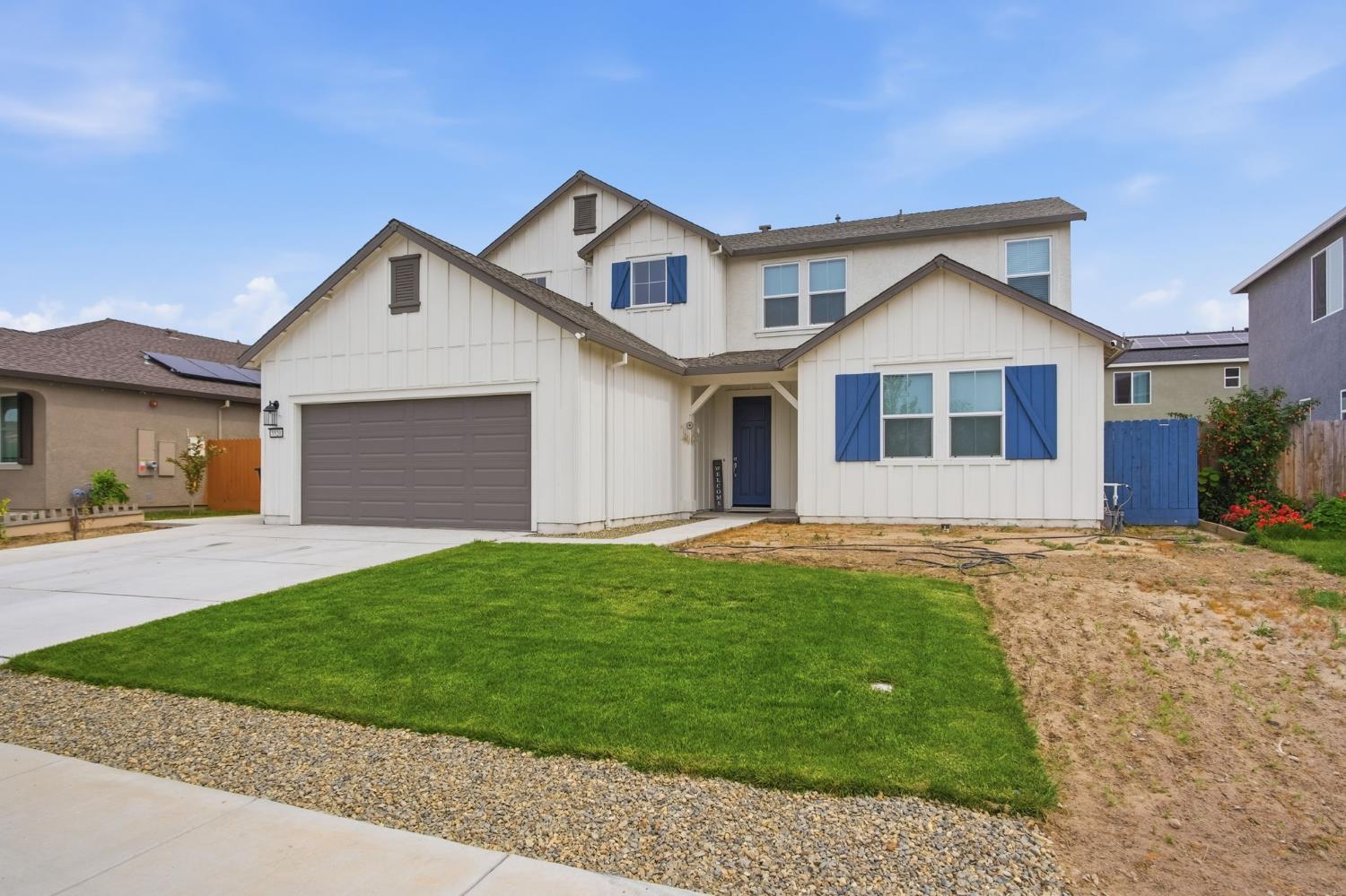 5520 Cora Way Keyes, CA 95328 - Photo 1 of 28 a front view of a house with a yard and garage