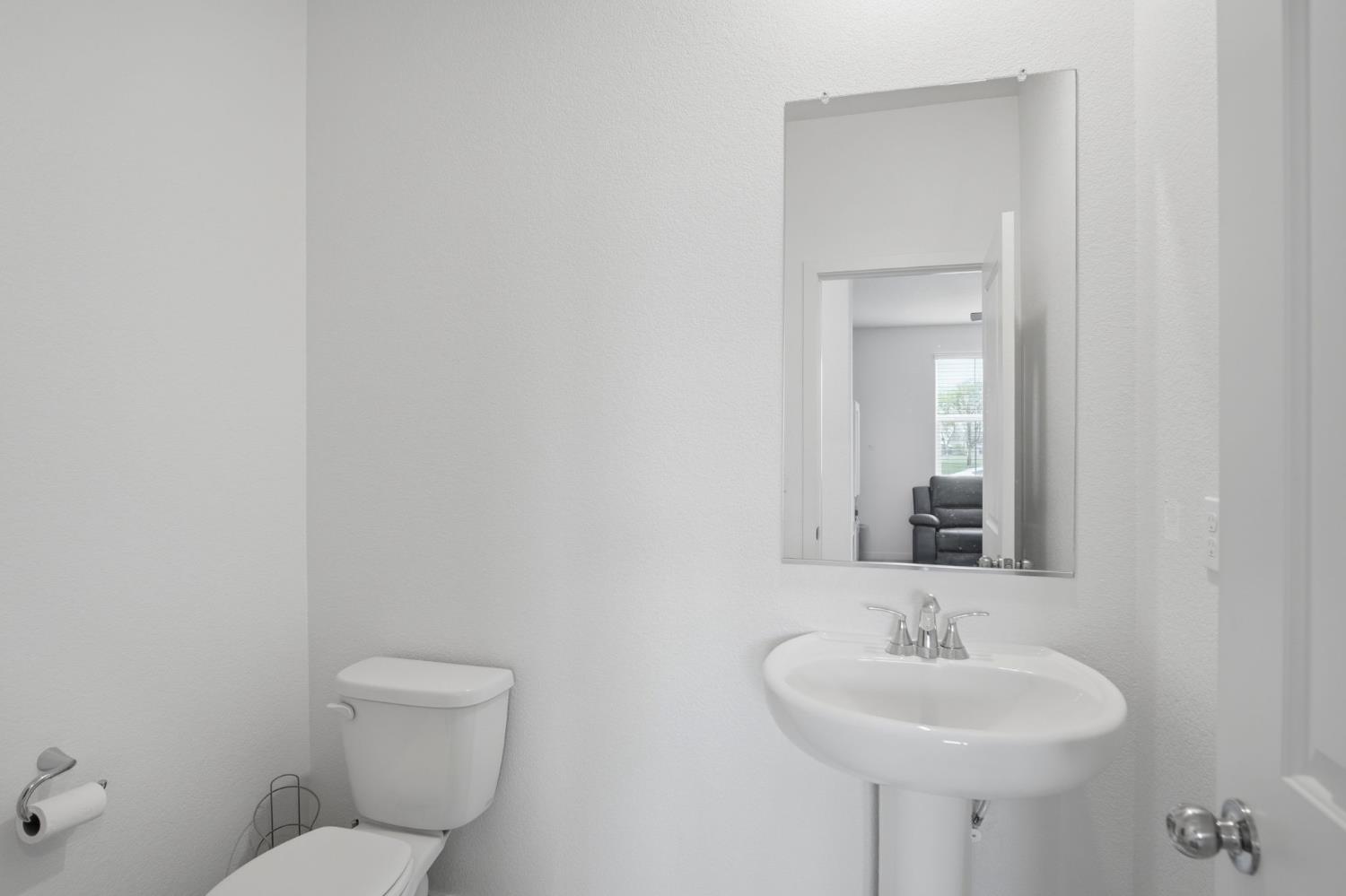 5520 Cora Way Keyes, CA 95328 - Photo 11 of 28 a bathroom with a toilet sink and mirror