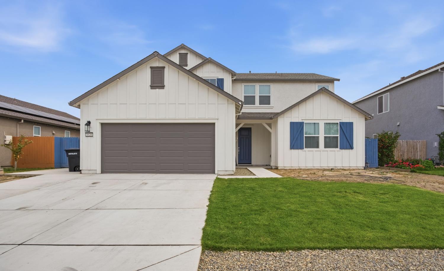 5520 Cora Way Keyes, CA 95328 - Photo 2 of 28 a front view of a house with a yard and garage