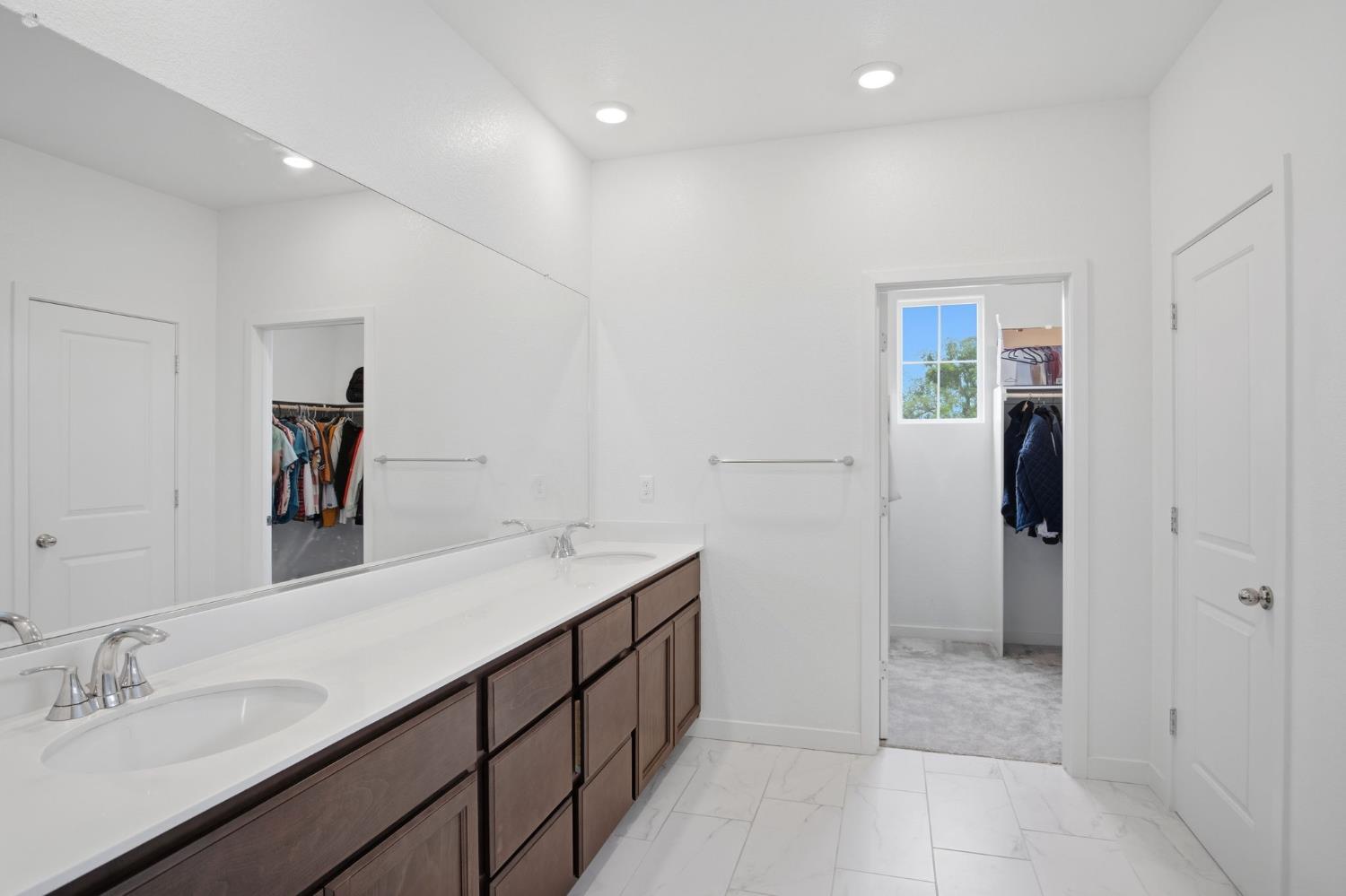 5520 Cora Way Keyes, CA 95328 - Photo 21 of 28 a spacious bathroom with a double vanity sink and a mirror