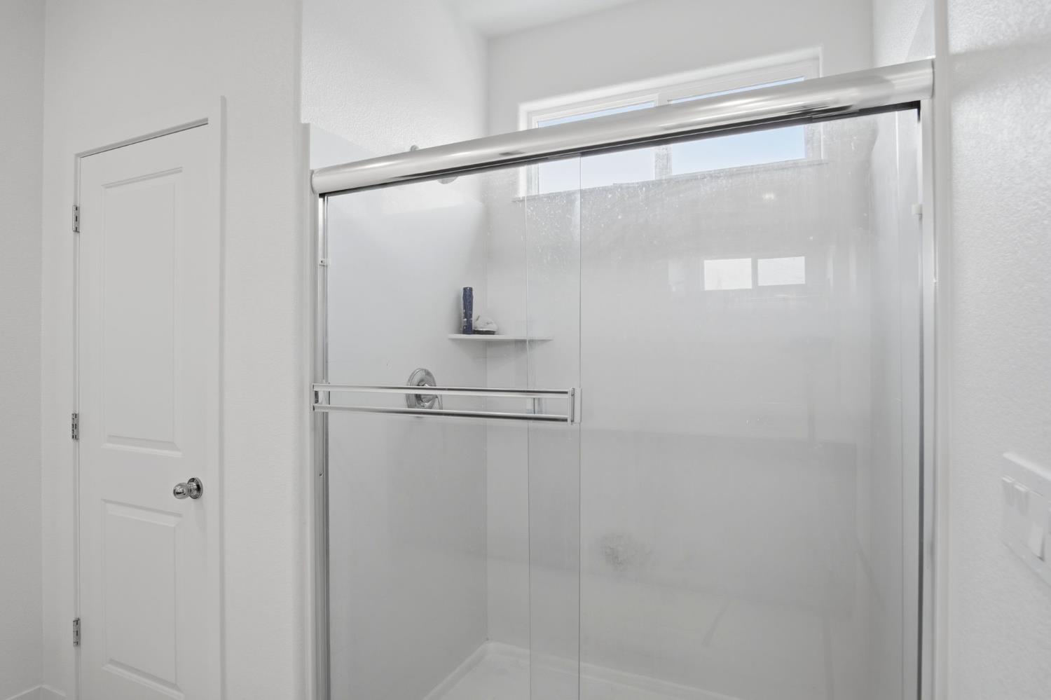 5520 Cora Way Keyes, CA 95328 - Photo 22 of 28 a bathroom with a glass shower door