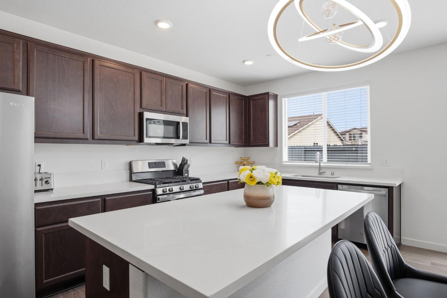 5520 Cora Way Keyes, CA 95328 - Photo 5 of 28 a kitchen with a sink a stove and cabinets