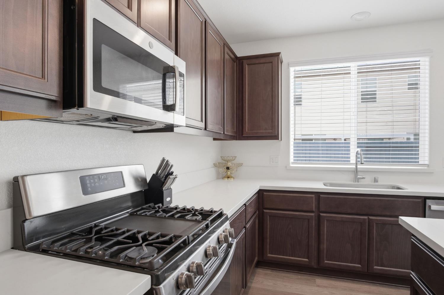 5520 Cora Way Keyes, CA 95328 - Photo 6 of 28 a kitchen with a stove and a sink
