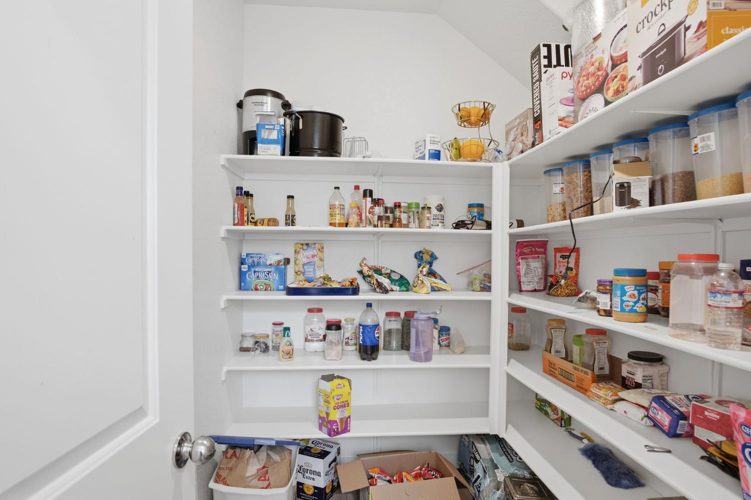 5520 Cora Way Keyes, CA 95328 - Photo 7 of 28 a cabinet with a sink and lots of different kinds of food