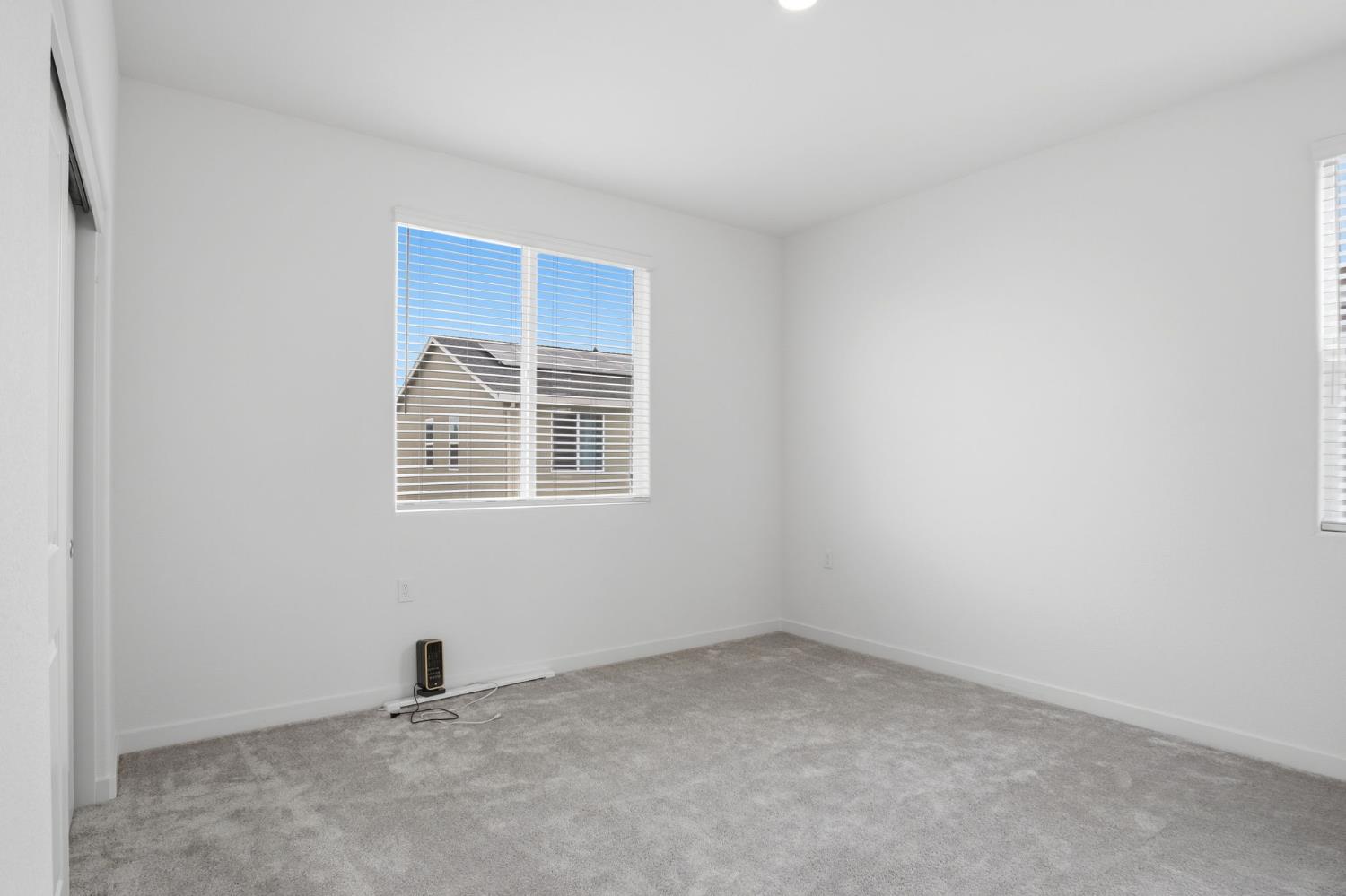 5520 Cora Way Keyes, CA 95328 - Photo 10 of 28 an empty room with windows