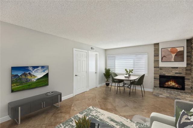 a living room with furniture flat screen tv and a fireplace