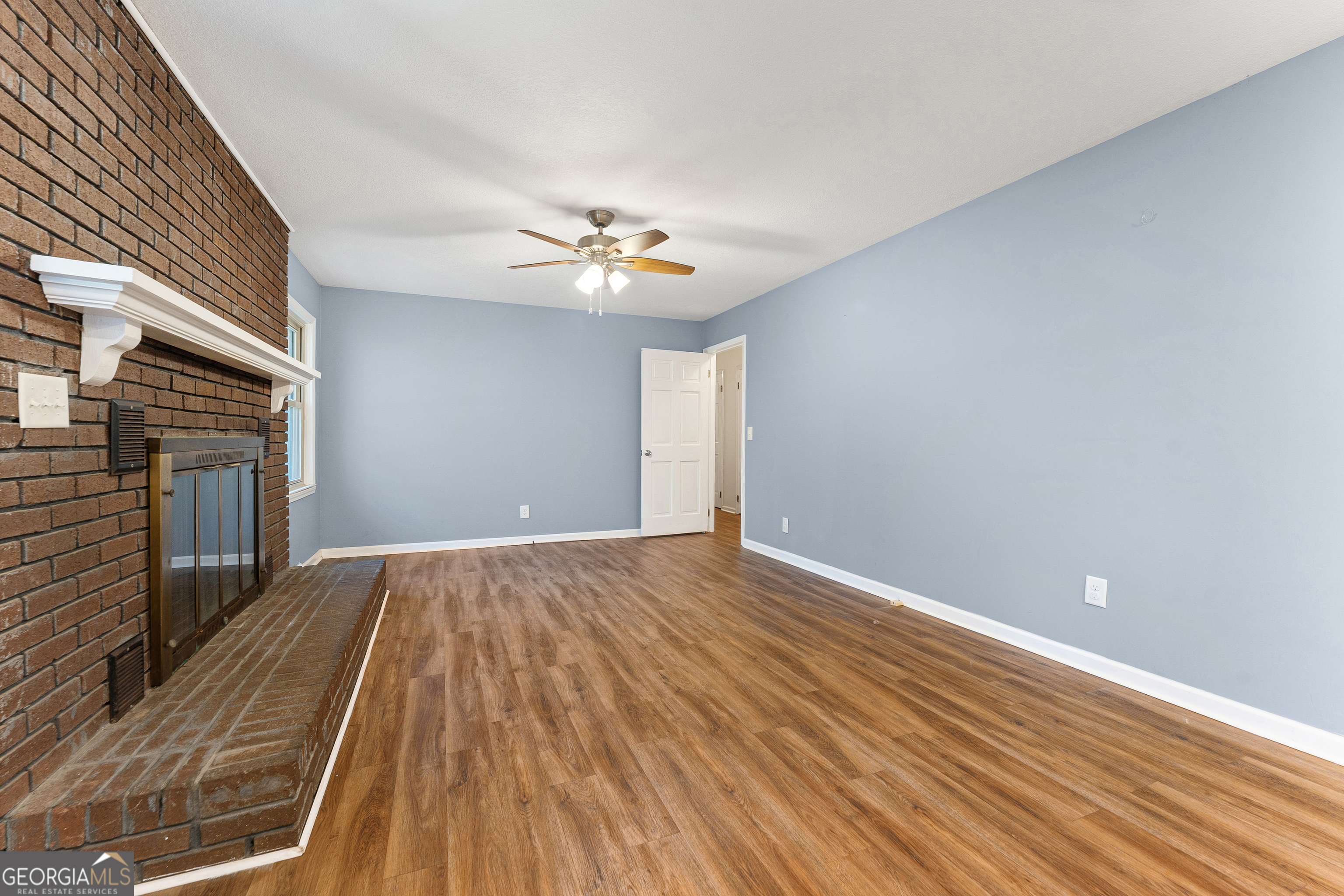 101 Fisher Drive Hartwell, GA 30643 - Photo 13 of 48 wooden floor in an empty room with a fireplace