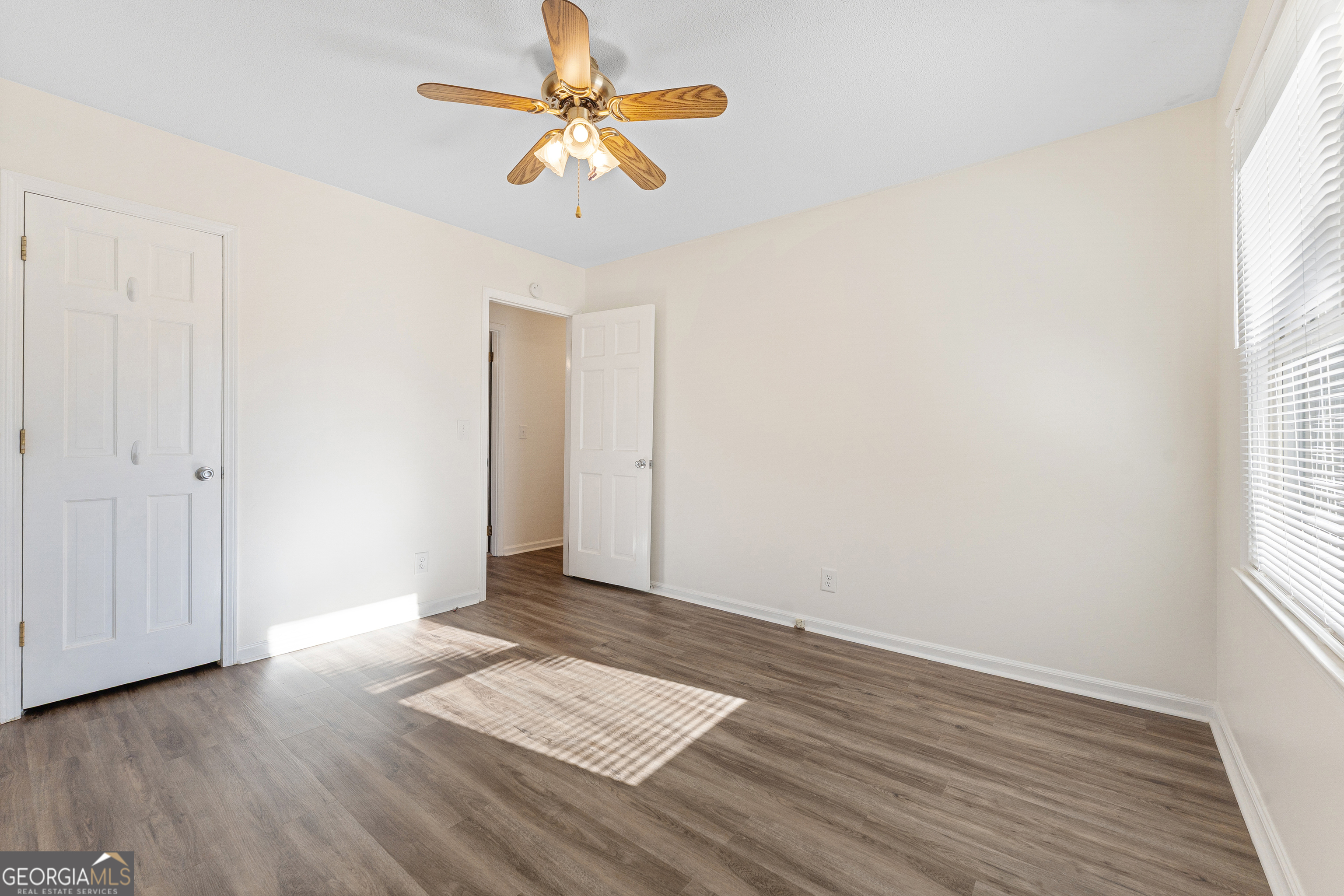 101 Fisher Drive Hartwell, GA 30643 - Photo 15 of 48 an empty room with wooden floor chandelier fan and windows