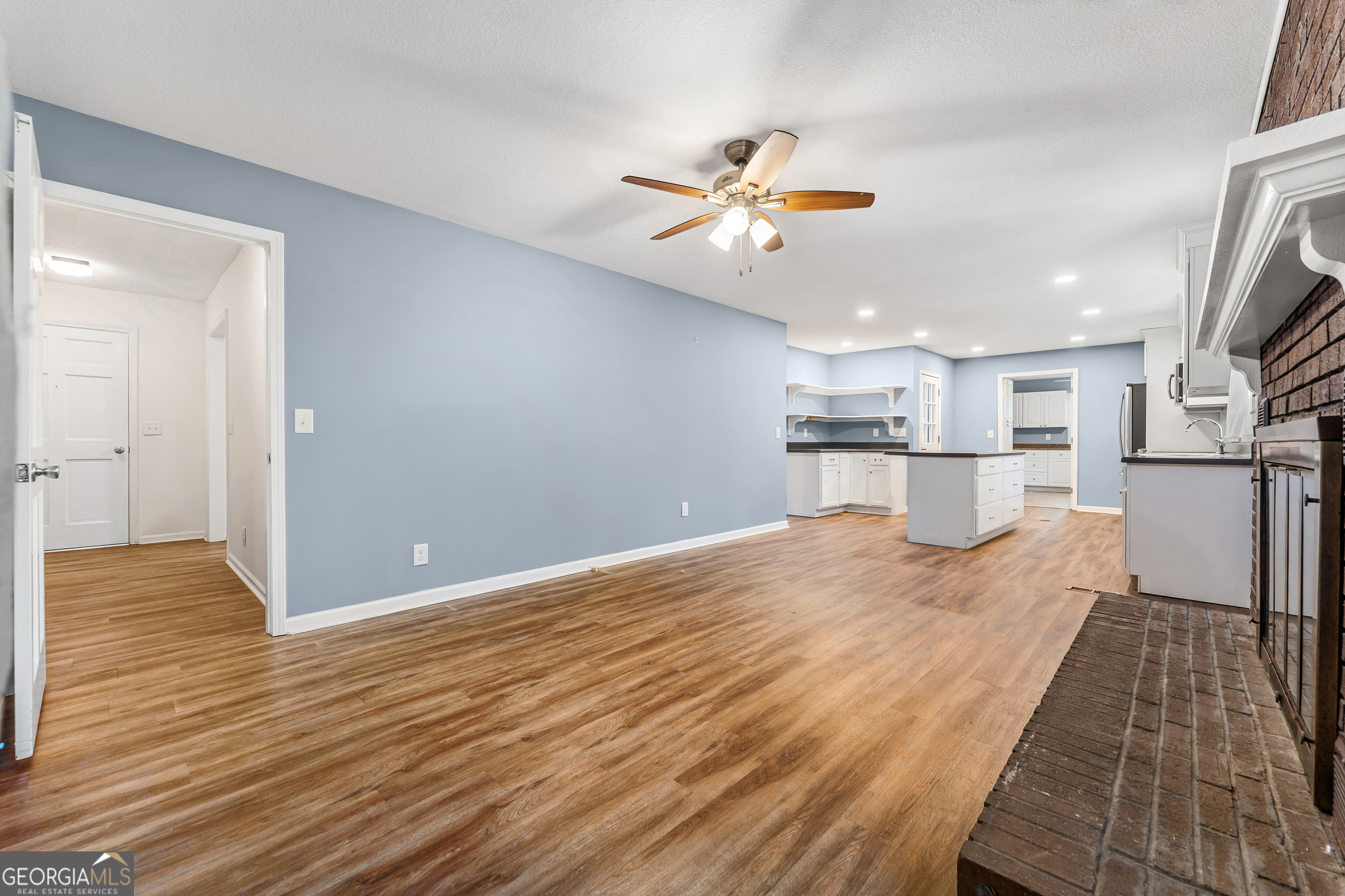 101 Fisher Drive Hartwell, GA 30643 - Photo 16 of 48 a view of a kitchen with wooden floor and a ceiling fan