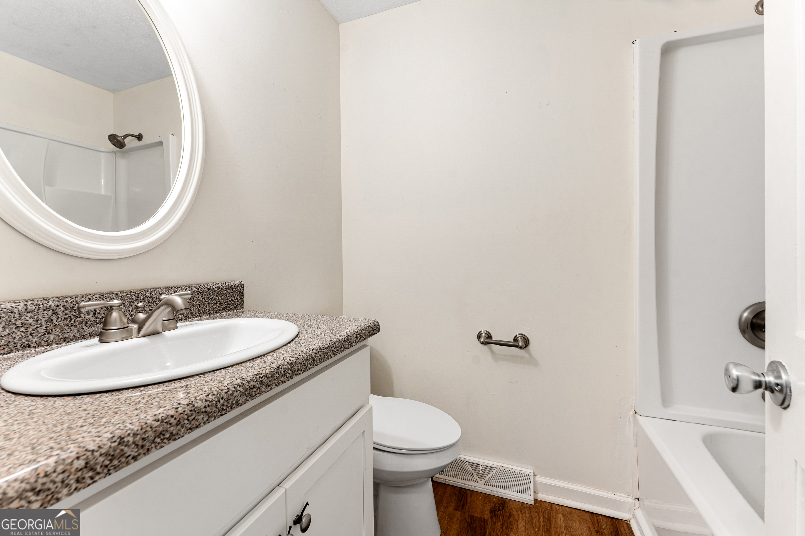 101 Fisher Drive Hartwell, GA 30643 - Photo 10 of 48 a bathroom with a granite countertop sink toilet and a mirror
