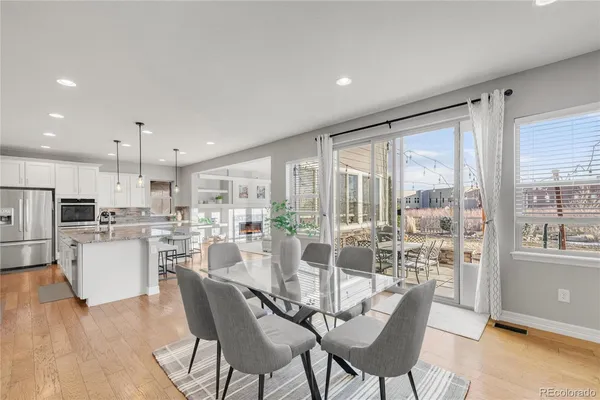 a dining room with furniture a large window and kitchen view