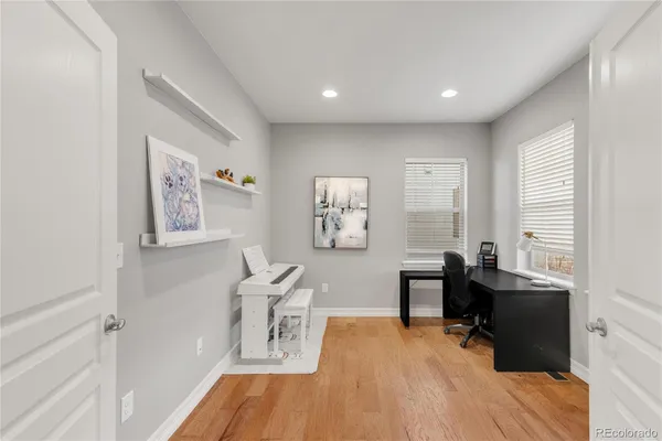 a view of a workspace with furniture and a window