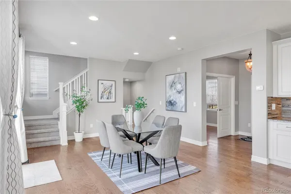 a view of a dining room with furniture and wooden floor