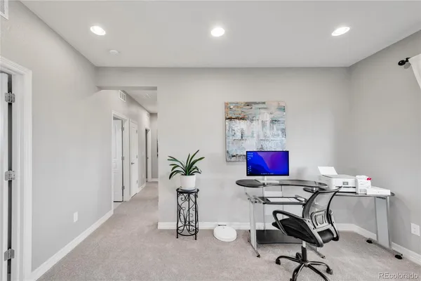 a view of a workspace with furniture and a potted plant