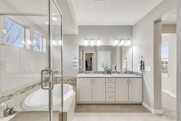 a spacious bathroom with a granite countertop sink a toilet and a mirror