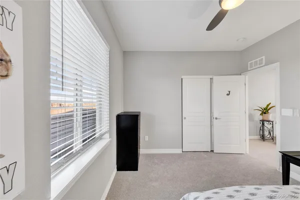 a view of empty room with window and wooden floor