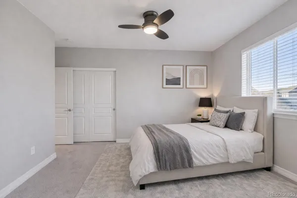 a bedroom with a bed and a chandelier