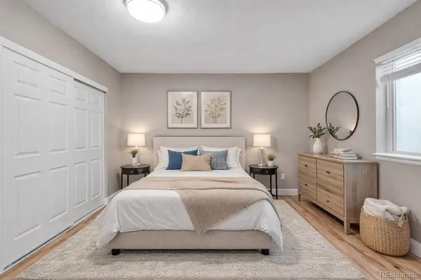 a bedroom with a bed a closet and large mirror