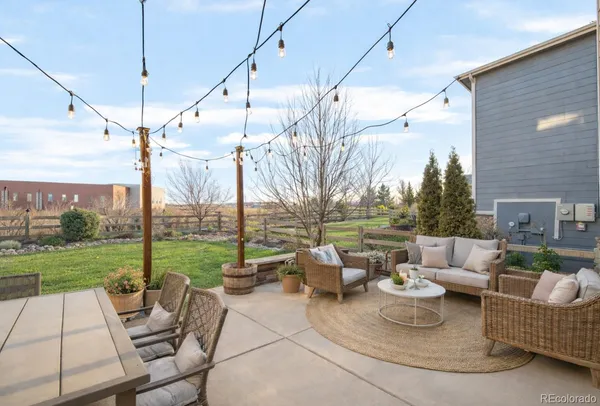 a view of a patio with couches chairs and a big yard