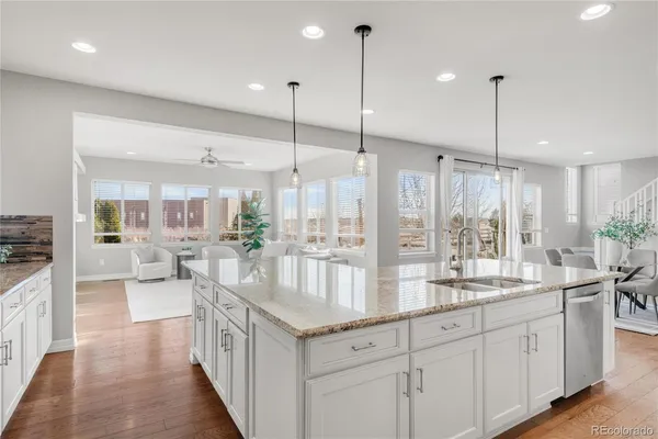 a large kitchen with kitchen island a large island in it