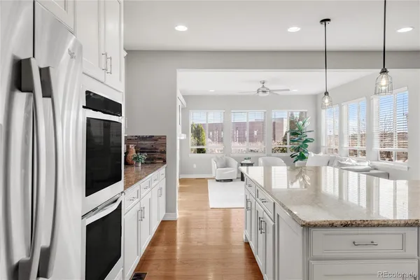 a kitchen with stainless steel appliances granite countertop a stove and refrigerator